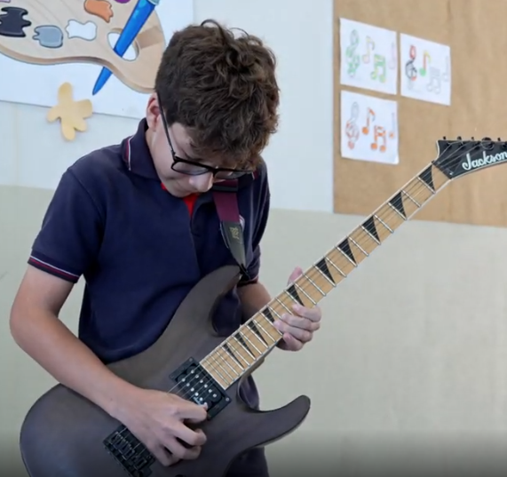 Student playing guitar